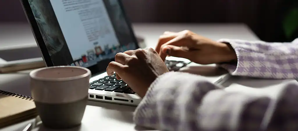 A SEO szövegíró laptopon állítja össze a weboldalra szánt releváns szöveges tartalmat.